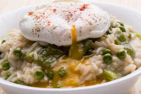 Pea risotto with egg fresh vegetarian pea risotto with poached egg Copyrig... Stock Photos