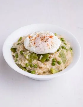 Pea risotto with egg fresh vegetarian pea risotto with poached egg Copyrig... Stock Photos