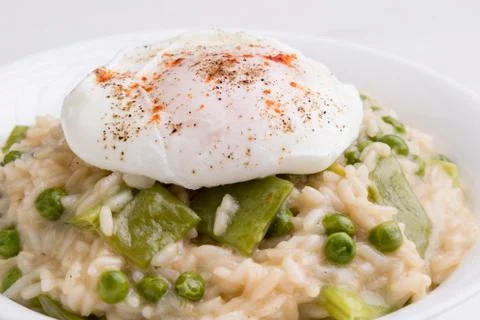 Pea risotto with egg Stock Photos