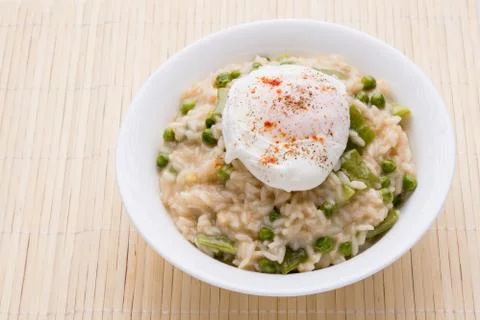 Pea risotto with egg Stock Photos