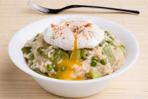 Pea risotto with egg Stock Photos