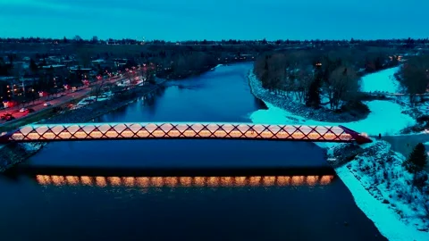 Peace Bridge Calgary reflection reveal, smooth downward aerial drone shot Stock Footage 332368012