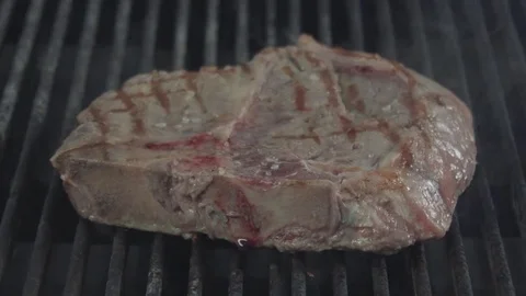 Peace of meat is turning over while frying Stock Footage 80907747