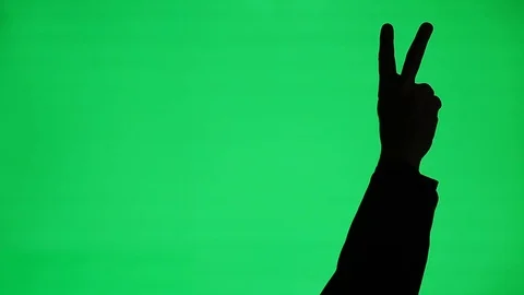 Peace or Victory Hand Gesture Silhouette on Green Screen Stock Footage 104097792