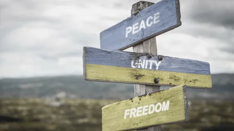 Peace unity freedom text quote on wooden signpost outdoors, written on the uk Stock Footage 171028446