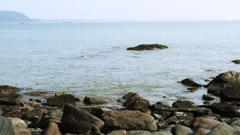 A peaceful 4K coastal landscape featuring gentle ocean waves washing over rocks Stock Footage 293282829