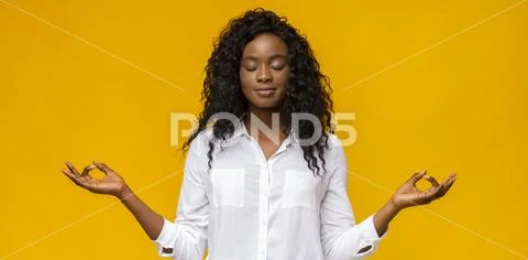 Peaceful afro girl with closed eyes practicing breathing yoga Stock Photos