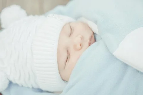 Peaceful baby lying on a bed while sleeping Photos