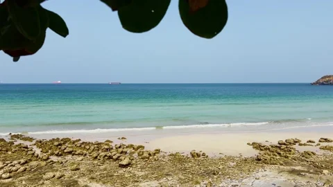 Peaceful beach scene with ocean waves and rocky shoreline Stock Footage 279501475