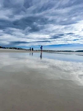 Peaceful beach scene with reflection Stock Photos