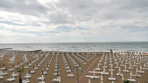 Peaceful beach scene with rows of white sun loungers Stock Footage 314595591