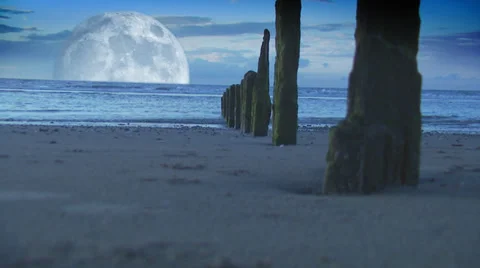 Peaceful beach scene, with waves lapping at ocean breakers and huge moon over 스톡 동영상 32961538
