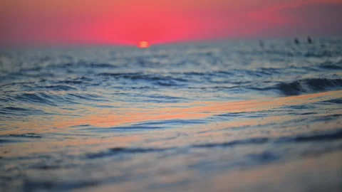 Peaceful beach wave under glowing evening sky, tranquil nature footage in 4K. Stock Footage 335550704