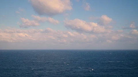 Peaceful blue ocean with puffy cloud sky, calm sea with horizon seascape Stock Footage