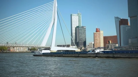Peaceful cityscape of centre where barge with cargo floats under bridge that Stockbeeldmateriaal 97471637