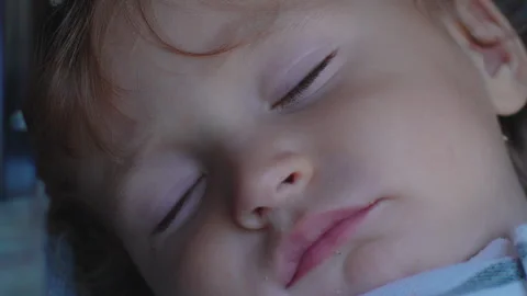 Peaceful close up of sleeping toddler during daytime stroller nap capturing.. Stock Footage 342828120