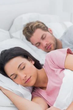 Peaceful couple sleeping in bed Stock Photos