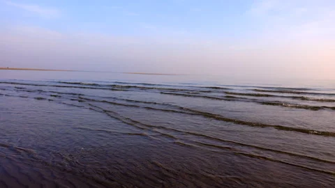 Peaceful easy going ocean waves in sunset light Stock Footage 233829682