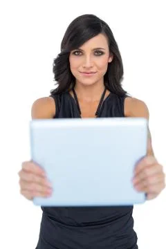 Peaceful elegant brown haired model holding tablet in front of her Stock Photos