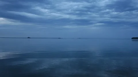Peaceful evening view of a large lake with small distant islands during blue hou Stock Footage 285553579