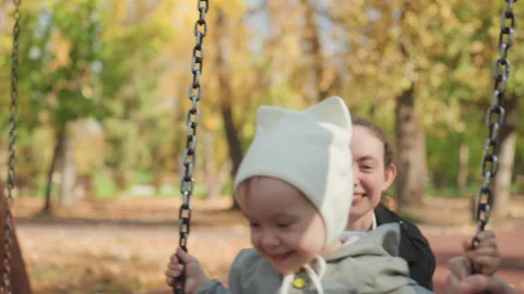 Peaceful fall outing together. Mother and baby enjoy autumn afternoon. Caring Stock Footage 330420719