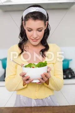 Peaceful gorgeous model holding healthy salad Stock Photos