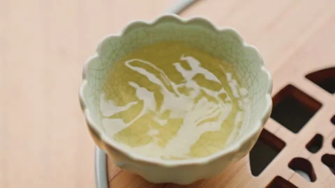 Peaceful green tea presentation. Serene scene featuring cup of green tea on Stock Footage 331747049