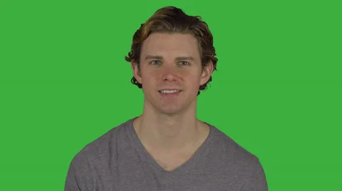 Peaceful looking man grins at camera (Green Key) Stock Footage 64951706