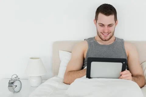 Peaceful man using a tablet computer 스톡 사진
