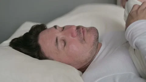 Peaceful Middle Aged Man Sleeping in Bed 스톡 동영상 142365706