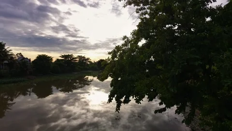 Peaceful morning view with dramatic sky reflecting on rural canal water Stock-Footage 342390961