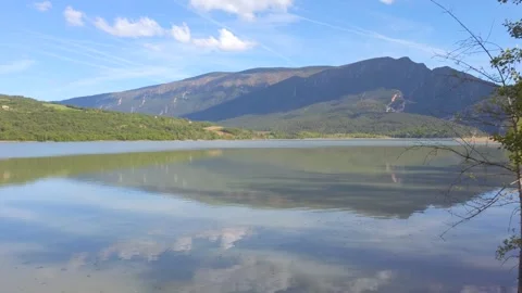 Peaceful Mountain Lake With Reflections and Green Reeds Stock Footage 335331462