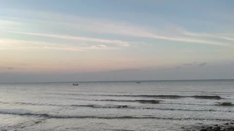 Peaceful Ocean Sunset with Gentle Waves and Distant Fishing Boats Video stock 341505889