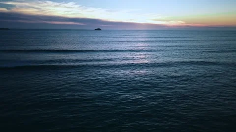 Peaceful ocean sunset with waves and rocks aerial shot Stock Footage 331194446