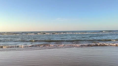 Peaceful Ocean Waves Rolling onto Sandy Shoreline Video stock 340489550