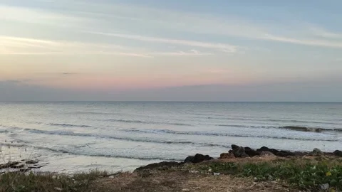 Peaceful Ocean Waves at Sunset on Rocky Beach 스톡 동영상 341505609