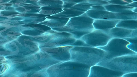 Peaceful oscillating aqua blue pool water with sun reflections Stock Footage 285419946