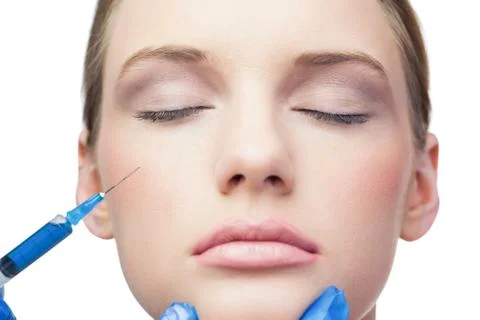 Peaceful pretty model having botox injection on the cheek Stock Photos