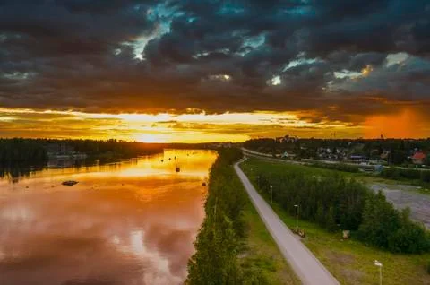 Peaceful reflection of sunlight on moving cloud and local rain on the river t Stock Photos