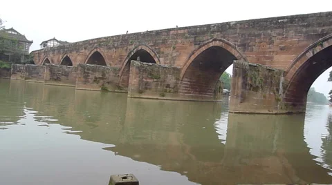 Peaceful river flowing through an old stone bridge in Pingle ancient town Stock Footage 41915357
