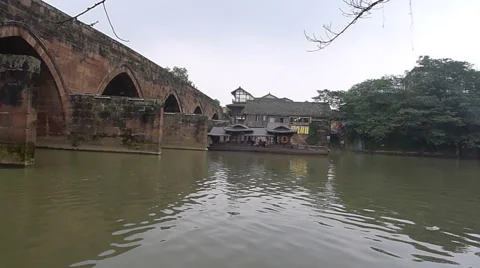 Peaceful river flowing through an old stone bridge in Pingle ancient town Stock Footage 42027465