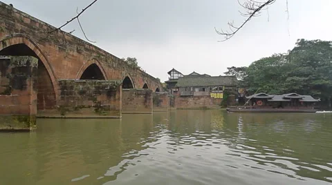 Peaceful river flowing through an old stone bridge in Pingle ancient town Stock Footage 42028847