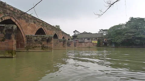 Peaceful river flowing through an old stone bridge in Pingle ancient town Stock Footage 42029113
