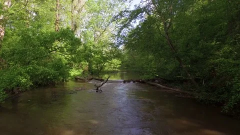 Peaceful River flows  hovering over muddy summer flow 4k drone Stock Footage 85189119