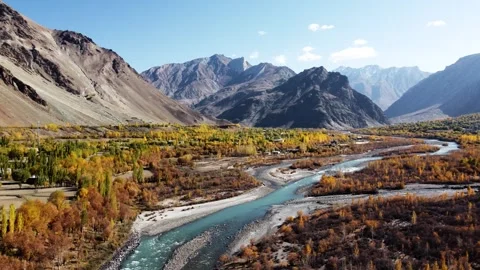 A peaceful river glows under autumn’s warm hues in the high Himalayas. 動画素材 310782099
