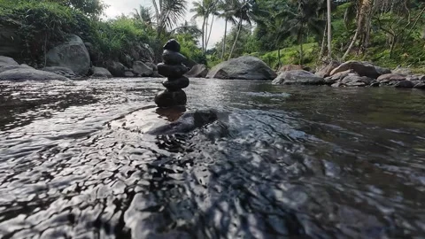 Peaceful River Stream with Balanced Stones and Flowing Water in 4K Stock Footage 337060633