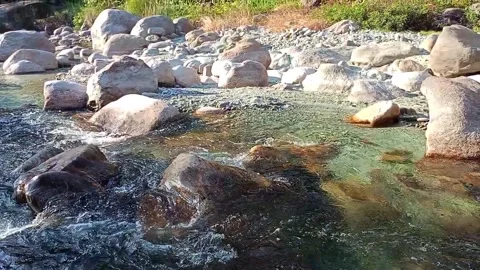 A peaceful river stream gliding over rocks Stock Footage 278054366