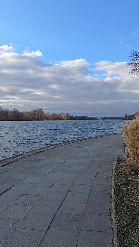 A peaceful riverside path with stunning views, ideal for relaxation and Stock Footage 304884721