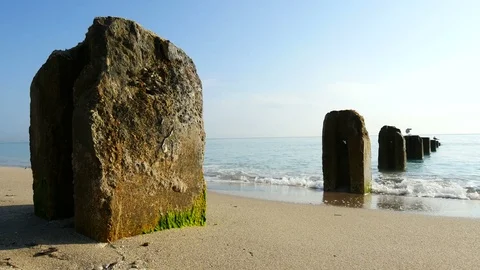 Peaceful scene of calm waves lapping up against a beautiful sandy beach Stock Footage 72580835