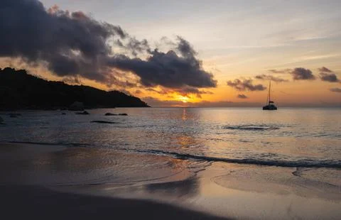 Peaceful scene featuring a tranquil beach at sunset. Seychelles Stock Photos